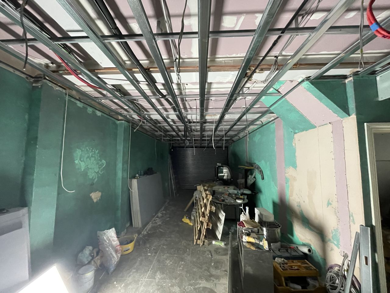 The unit as we took it on, stripped to bare walls with all services exposed.