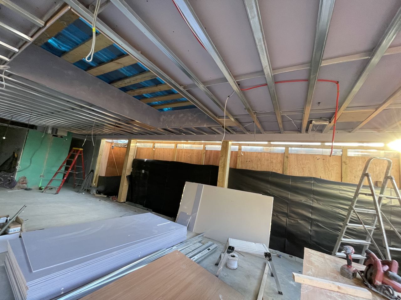 New ceiling grid and structural framing set out before boarding and insulation.