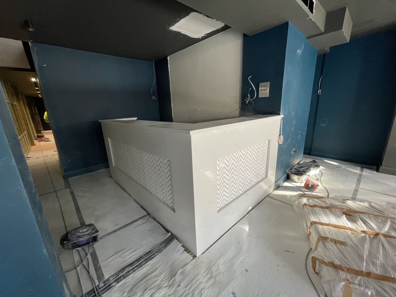 Bar clad and walls painted, joinery complete before the lighting went in.