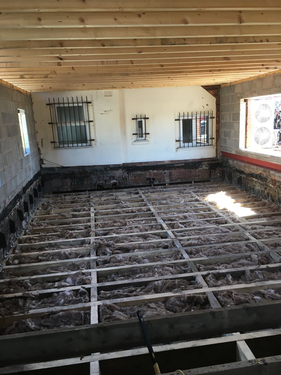 New floor joists set out across the full footprint.