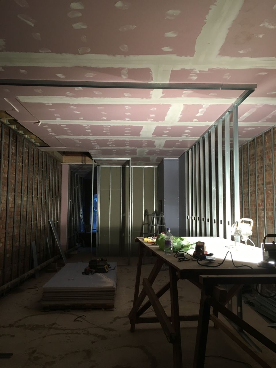 Stud partitions forming the new layout through the room.
