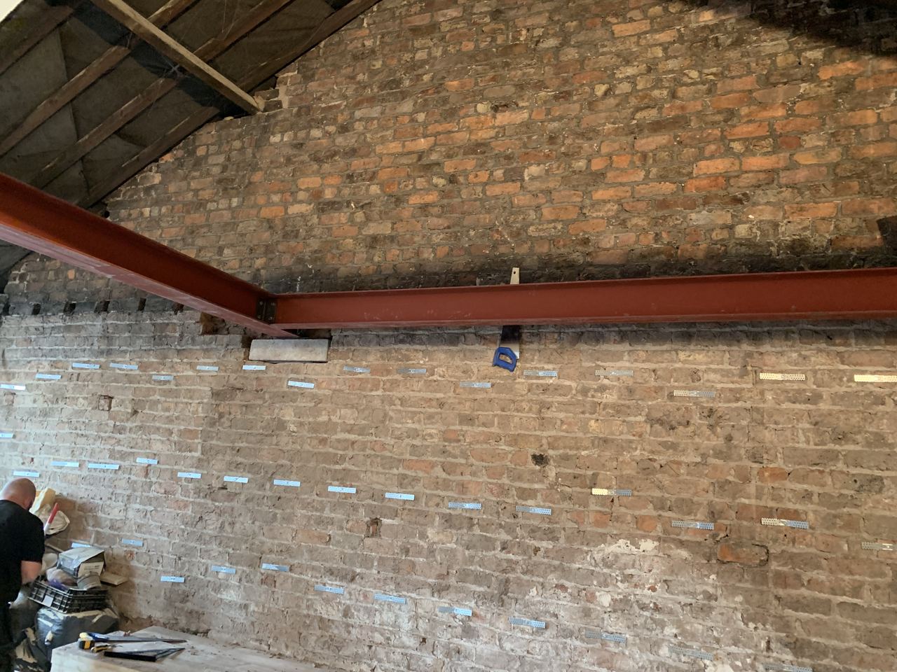 Beam bearing onto the original brickwork before making good.