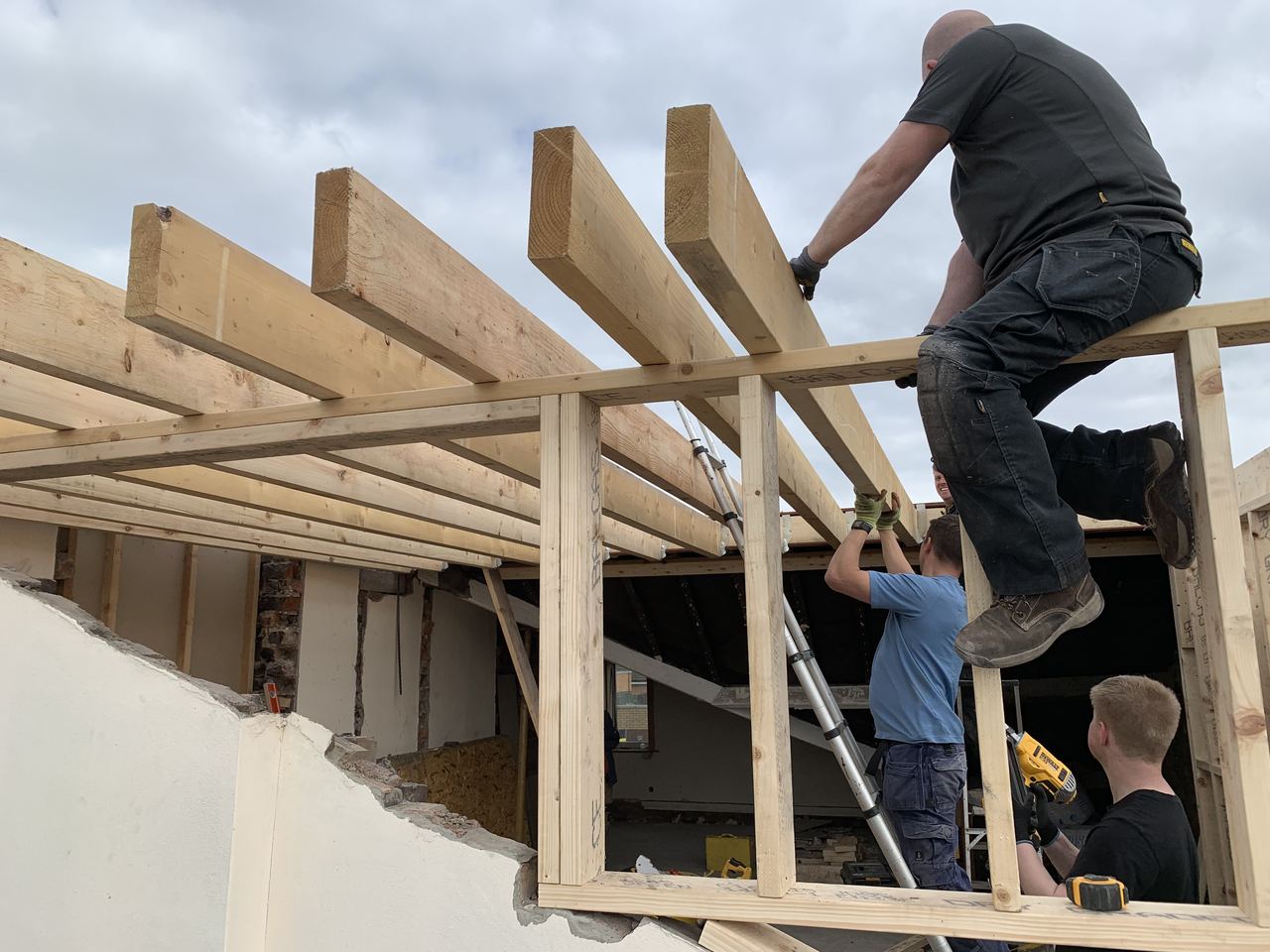 Carpenters framing the new dormer structure on site.