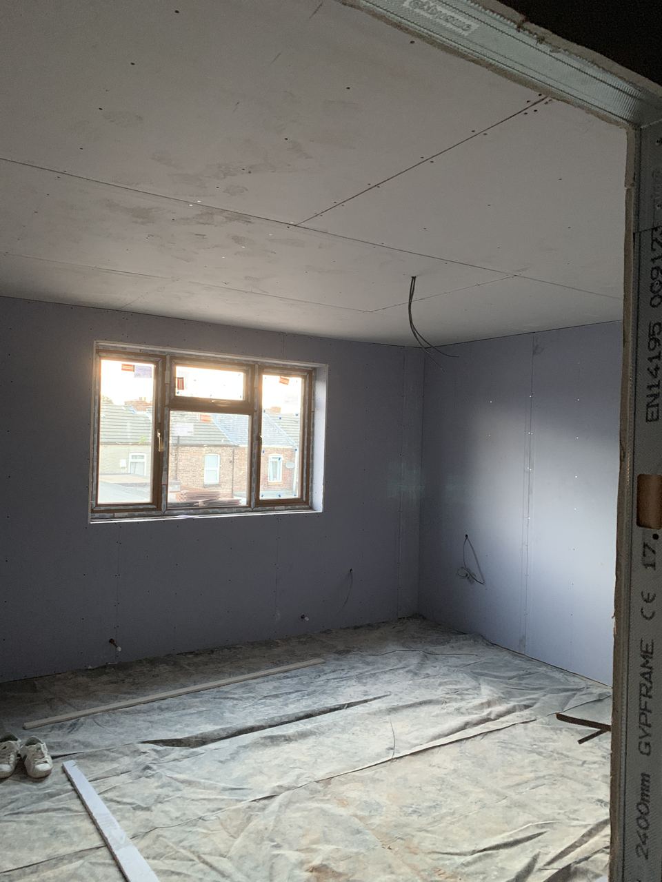 Plastered and dust-sheeted, ready for decoration