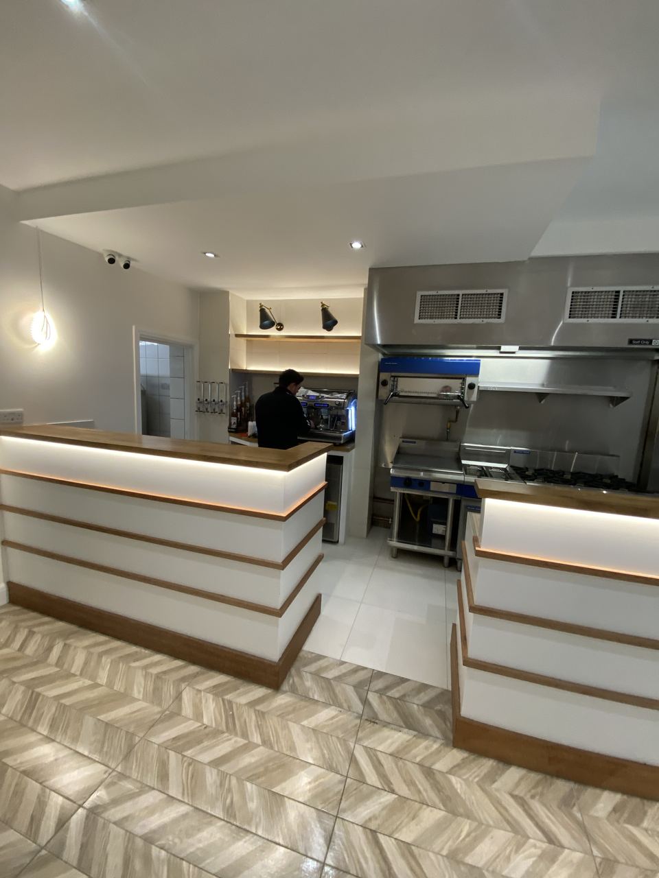 Milano Pizzeria: bespoke counter and open kitchen from the dining room