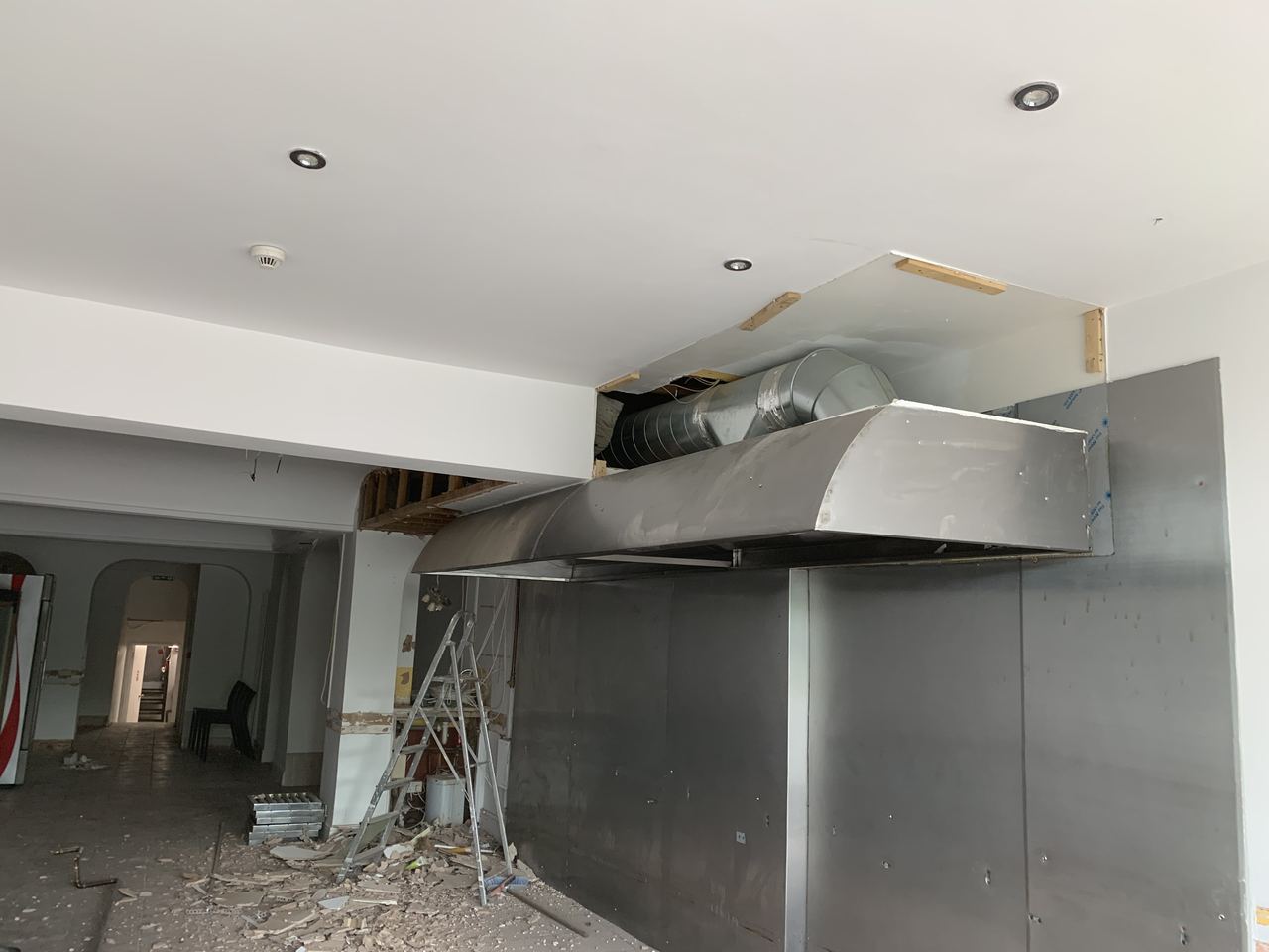 Commercial extraction canopy installed over the kitchen area.